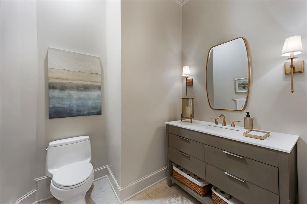 6615 Meadow Road Dallas, TX 75230 - Photo 17 of 39 Updated 1st floor guest powder bath is situated in a private hall in between the kitchen, dining and family room.