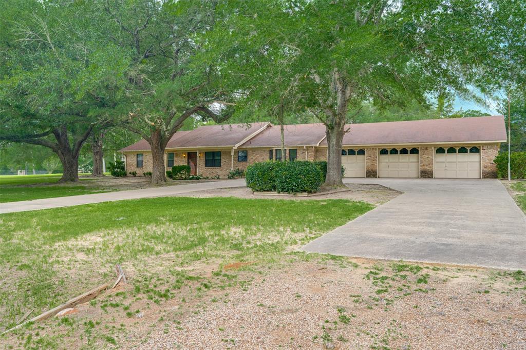 8798 Hill N Dale Road Tyler, TX 75709 - Photo 1 of 31 Brick exterior with a brown roof and a three-car garage
