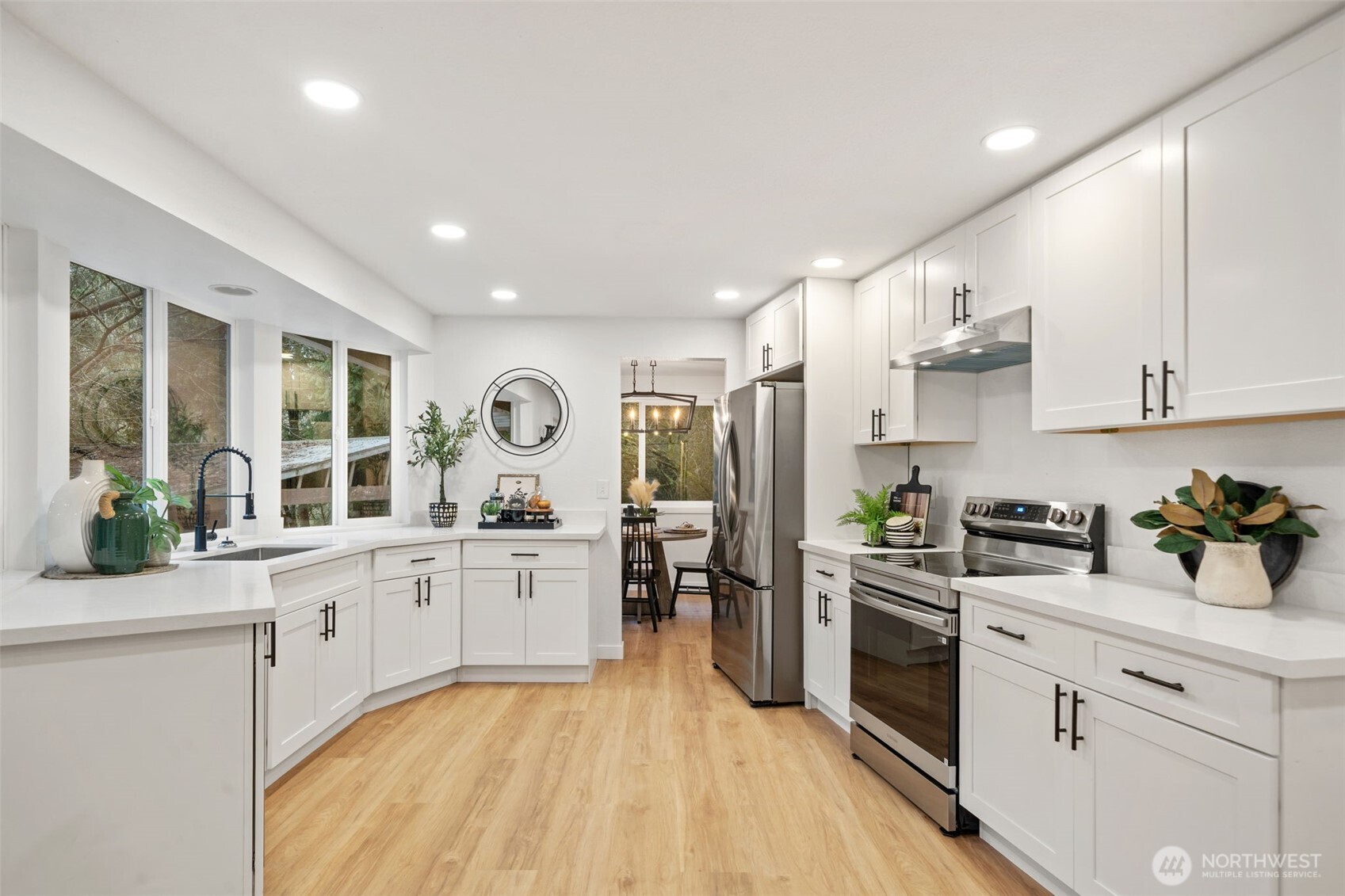 13080 Old Military Road Northeast Poulsbo, WA 98370 - Photo 13 of 29 a large kitchen with stainless steel appliances granite countertop a lot of counter space and wooden floors