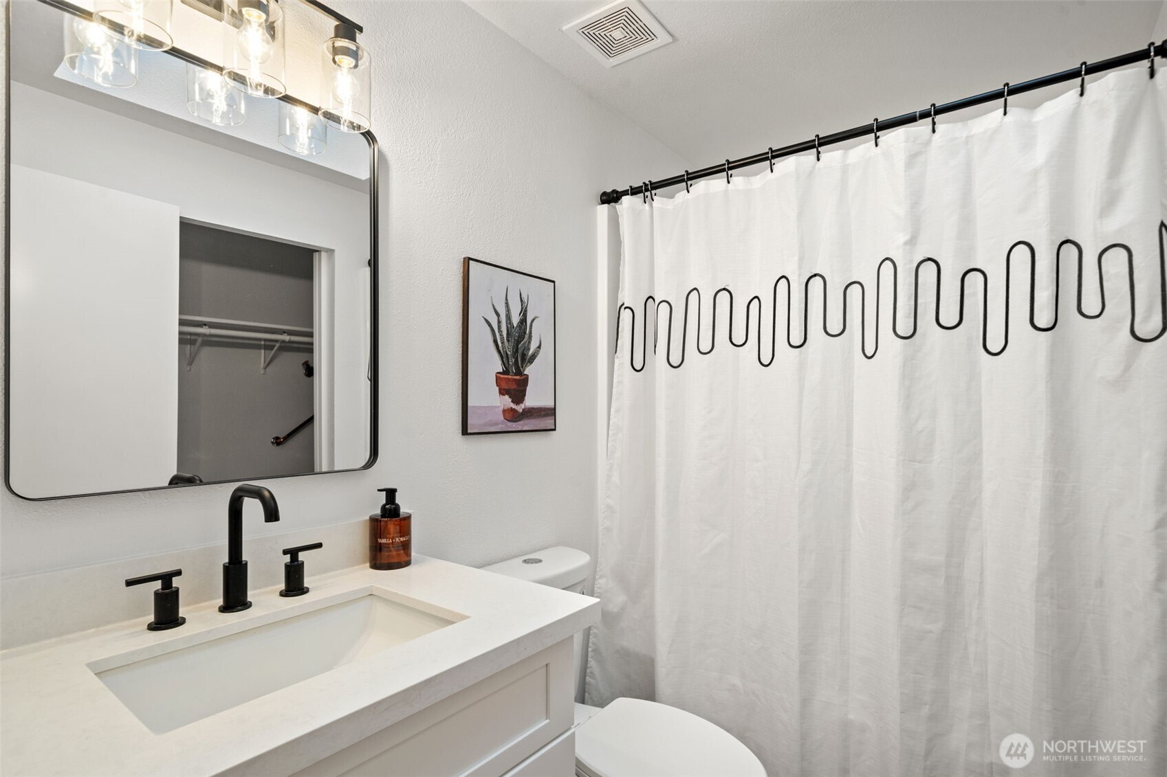 13080 Old Military Road Northeast Poulsbo, WA 98370 - Photo 14 of 29 a bathroom with a sink a mirror and a toilet