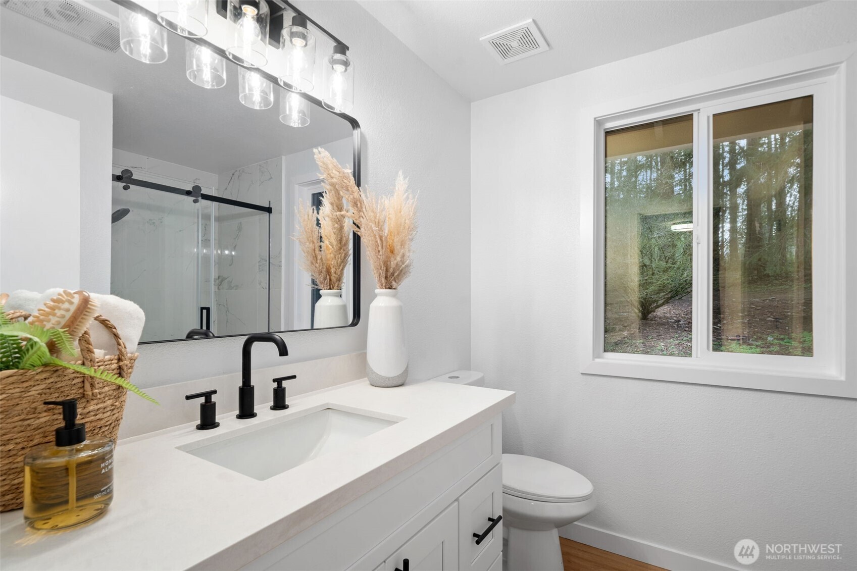 13080 Old Military Road Northeast Poulsbo, WA 98370 - Photo 19 of 29 a bathroom with a sink a toilet and a mirror