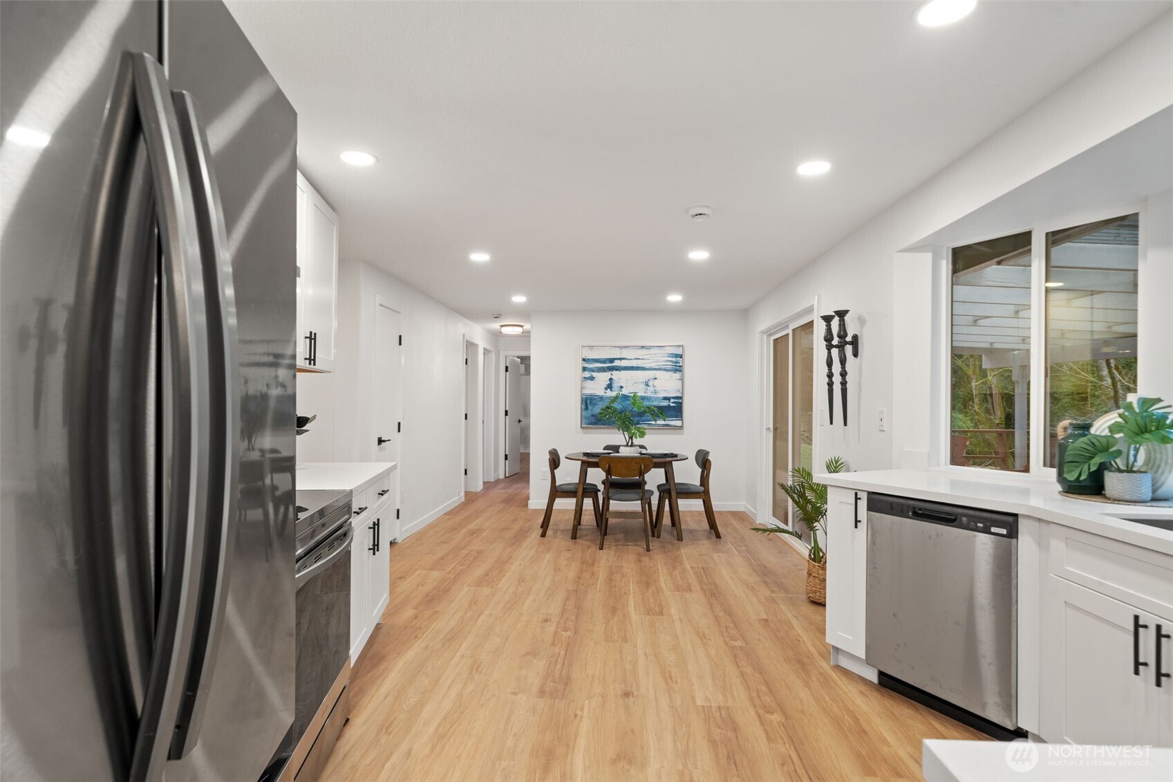 13080 Old Military Road Northeast Poulsbo, WA 98370 - Photo 8 of 29 an open kitchen with a table and chairs