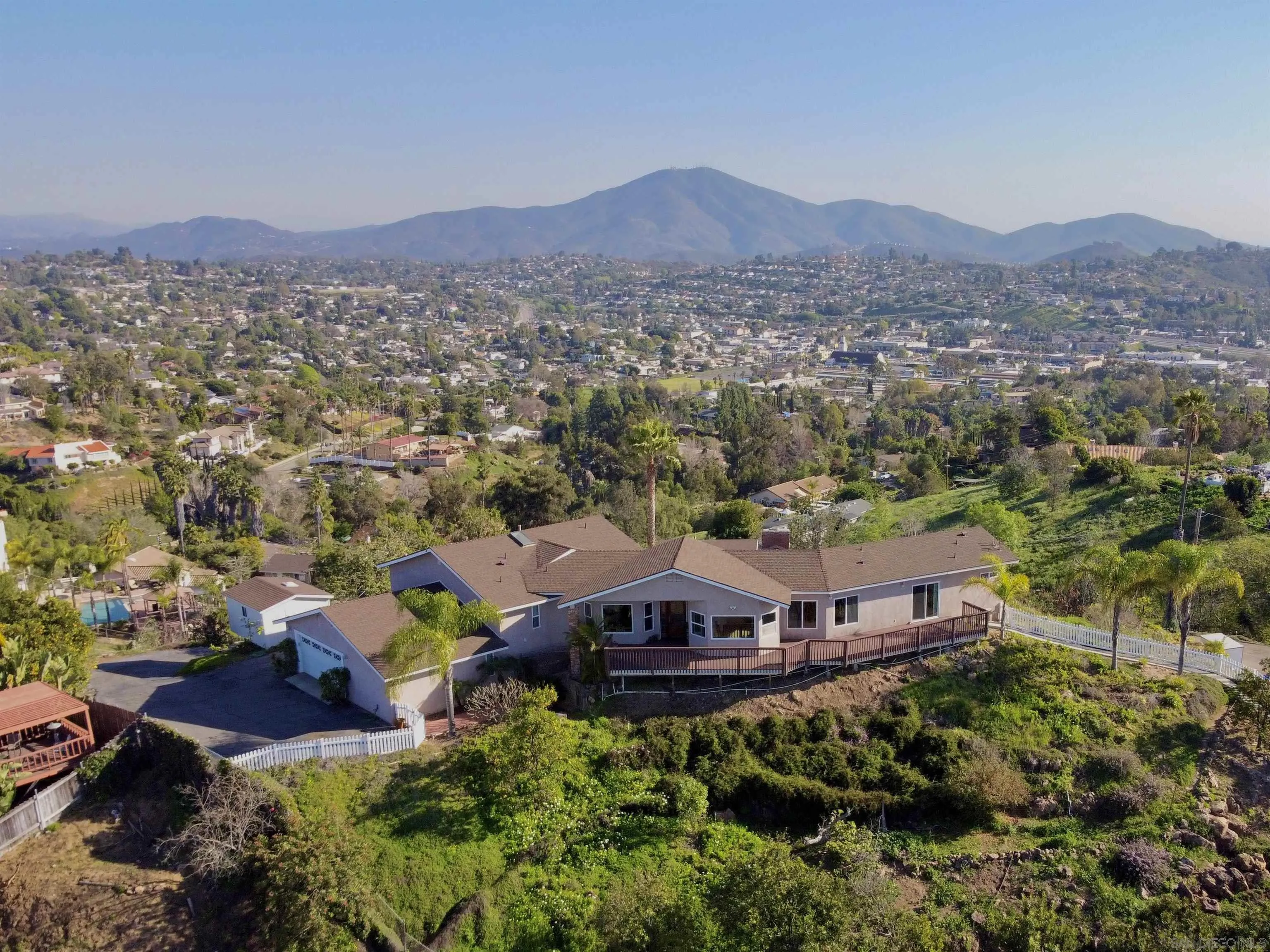 4375 North Rogers Road Spring Valley, CA 91977 - Photo 1 of 34 an aerial view of a house with a mountain in the background