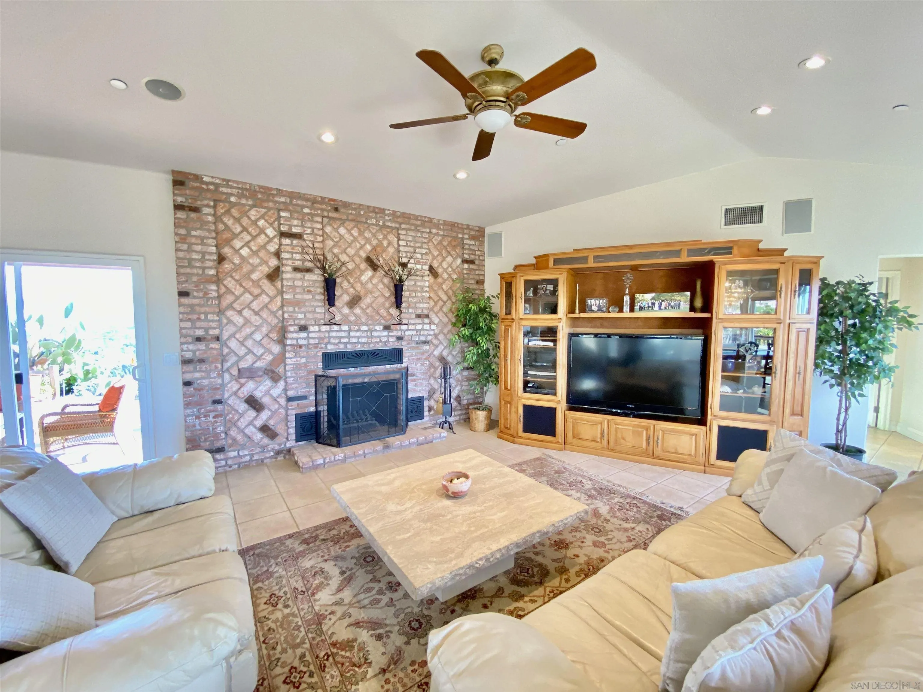 4375 North Rogers Road Spring Valley, CA 91977 - Photo 13 of 34 a living room with furniture a flat screen tv and a fireplace