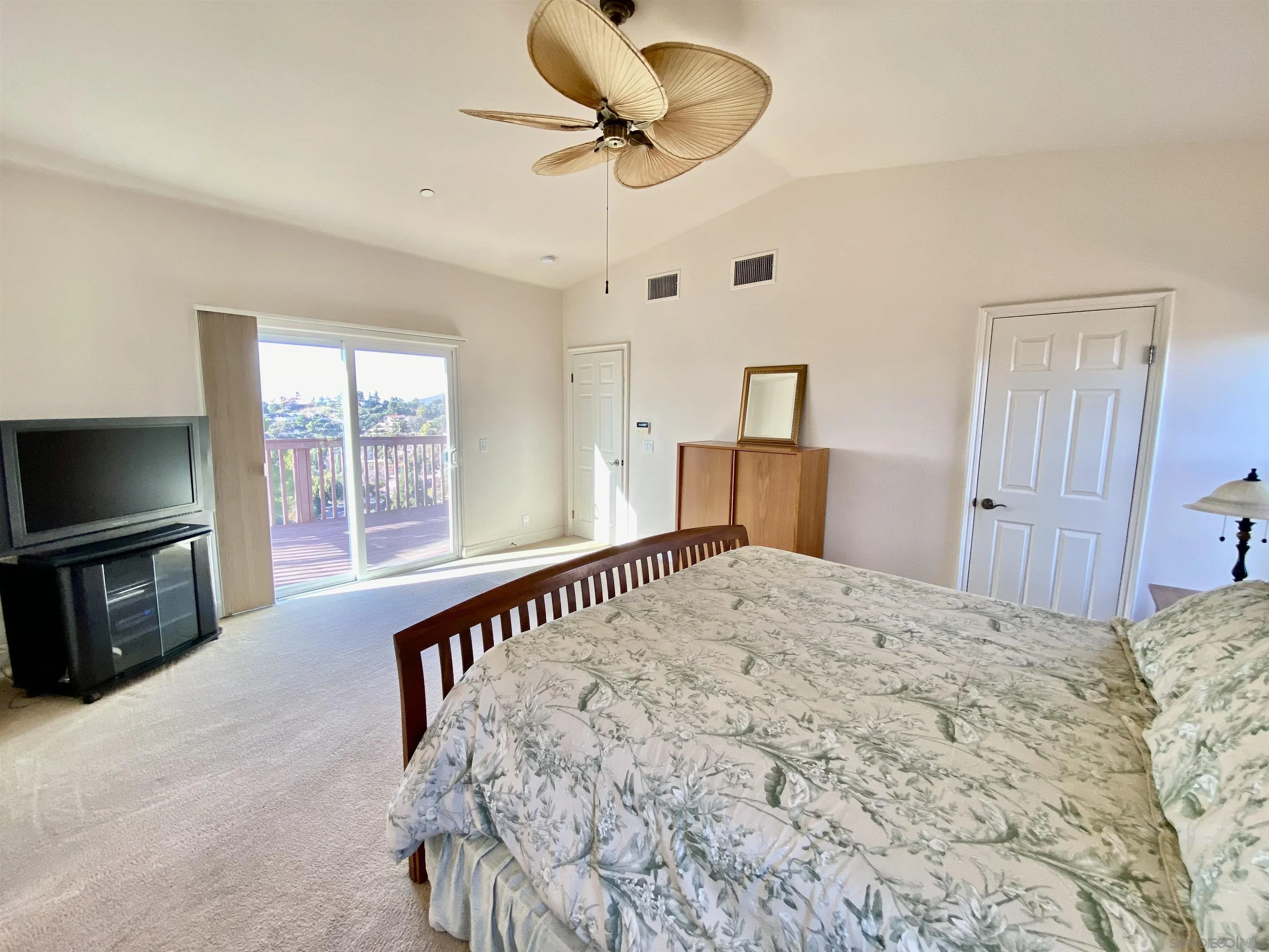 4375 North Rogers Road Spring Valley, CA 91977 - Photo 16 of 34 a spacious bedroom with a bed and a flat screen tv