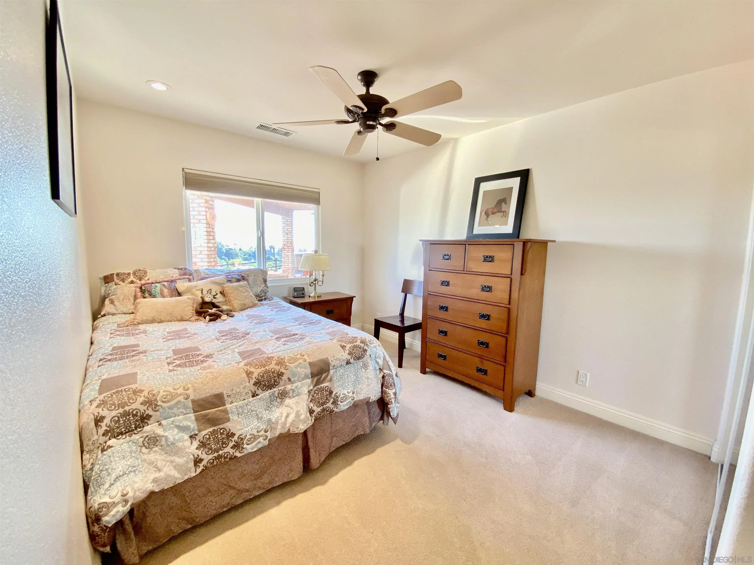 4375 North Rogers Road Spring Valley, CA 91977 - Photo 19 of 34 a spacious bedroom with a bed and a chandelier