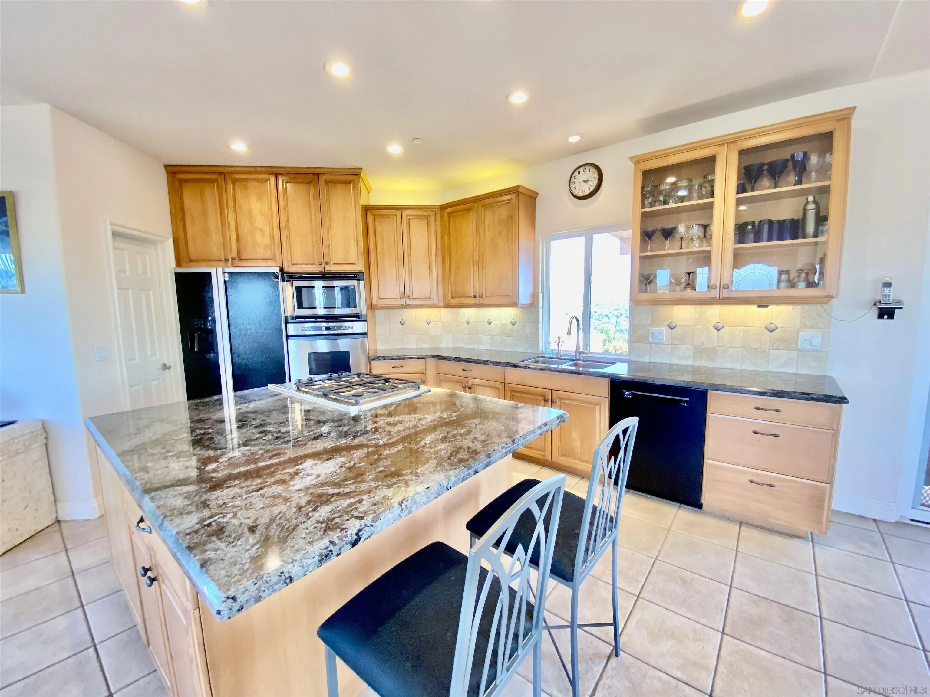 4375 North Rogers Road Spring Valley, CA 91977 - Photo 10 of 34 a kitchen with kitchen island granite countertop wooden cabinets and counter space