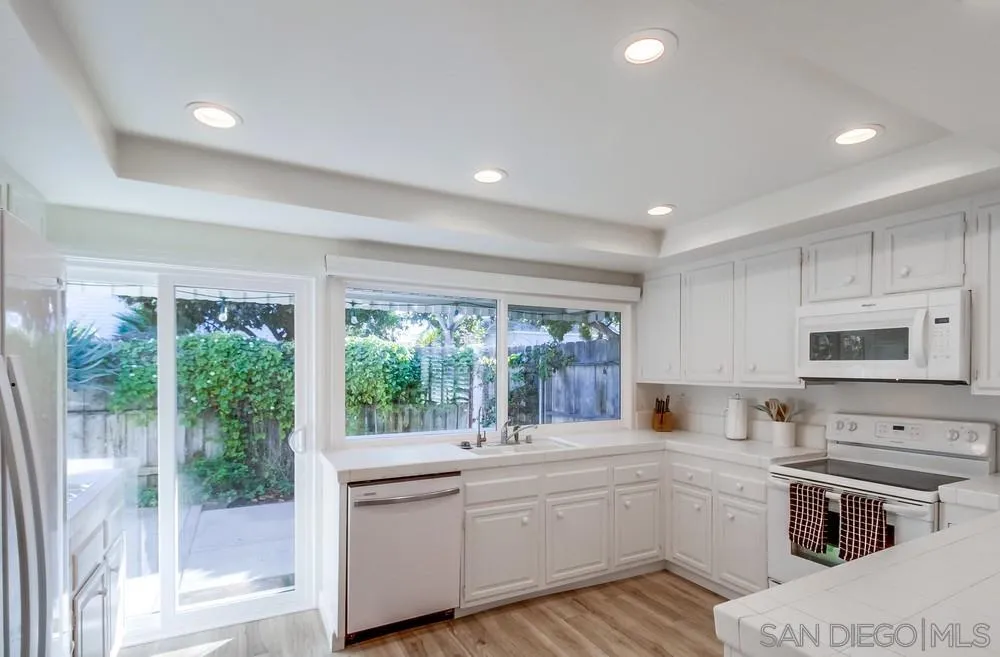 10 GingerTree Lane Coronado, CA 92118 - Photo 24 of 68 a kitchen with sink a stove and microwave