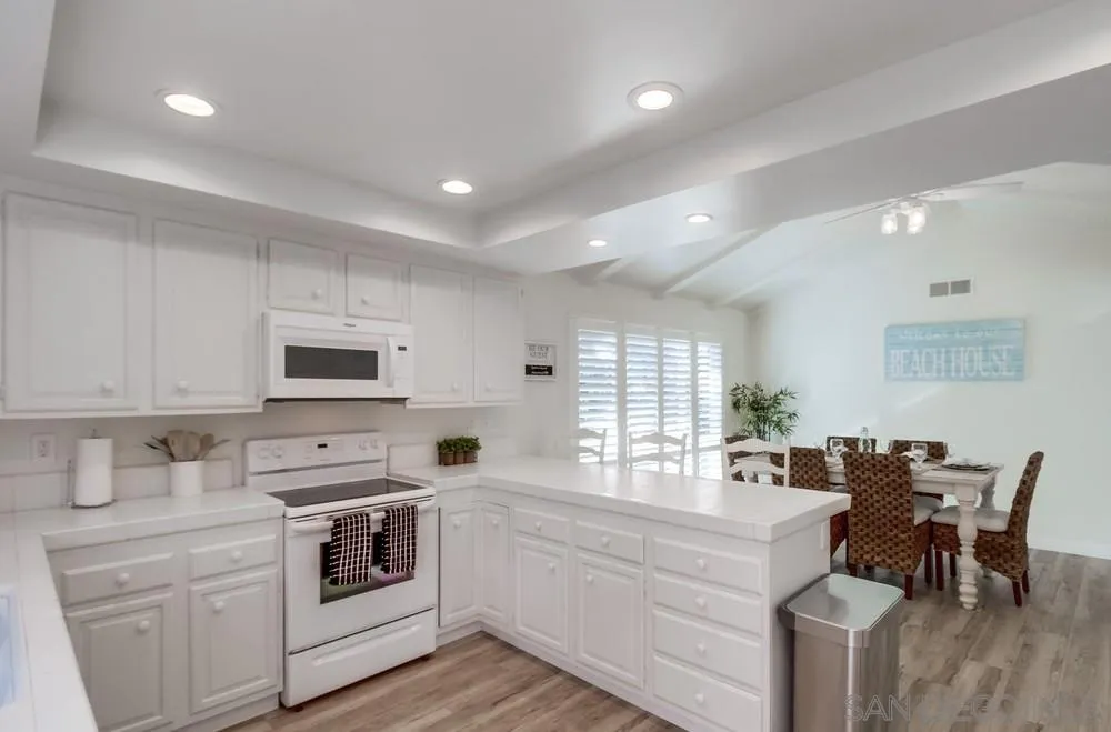 10 GingerTree Lane Coronado, CA 92118 - Photo 25 of 68 a kitchen with white cabinets and appliances