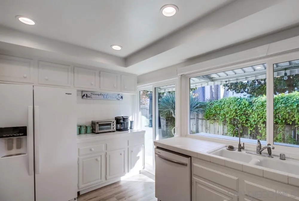 10 GingerTree Lane Coronado, CA 92118 - Photo 27 of 68 a kitchen with kitchen island a sink stainless steel appliances and cabinets