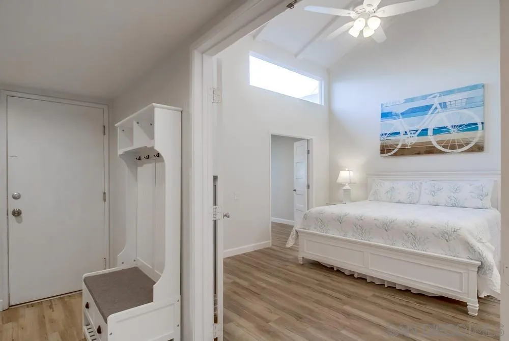 10 GingerTree Lane Coronado, CA 92118 - Photo 30 of 68 a bedroom with a bed and a chandelier