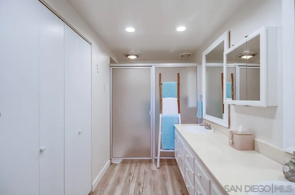 10 GingerTree Lane Coronado, CA 92118 - Photo 37 of 68 a bathroom with a sink and a large mirror
