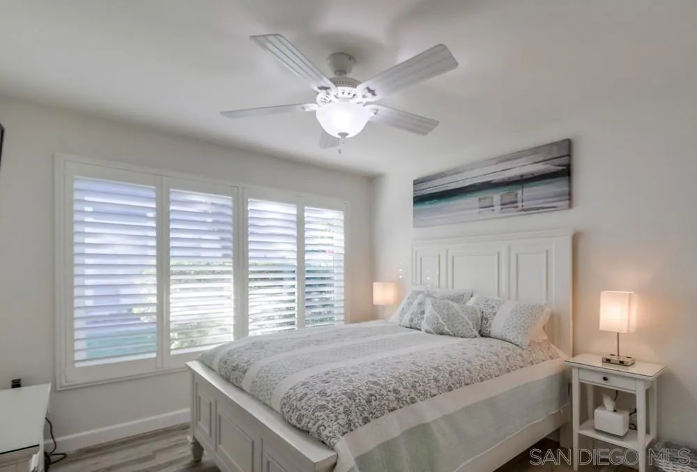 10 GingerTree Lane Coronado, CA 92118 - Photo 42 of 68 a bedroom with a large bed and a chandelier