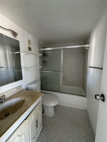 a bathroom with a sink a toilet a shower and vanity