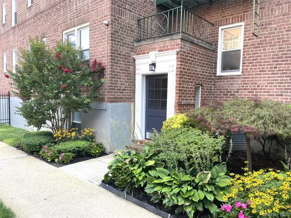a view of a house with potted plants