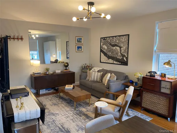 a living room with furniture and a chandelier