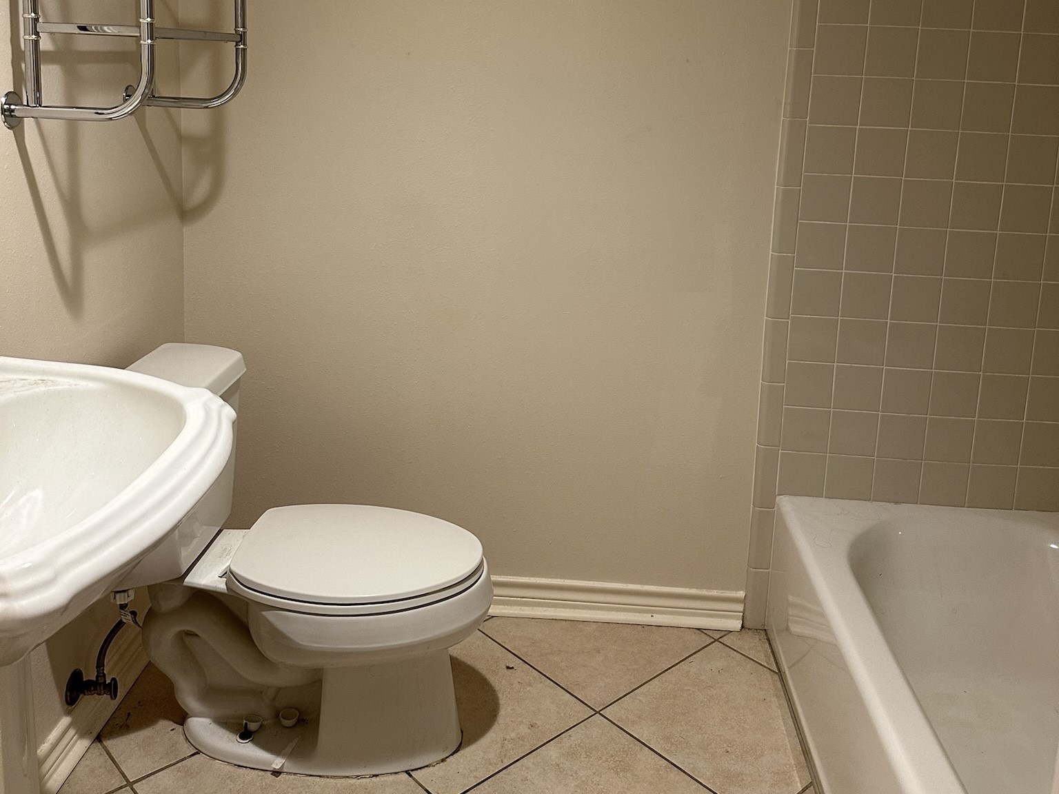 5659 Lymbar Drive Houston, TX 77096 - Photo 12 of 26 a white toilet sitting next to a bath tub