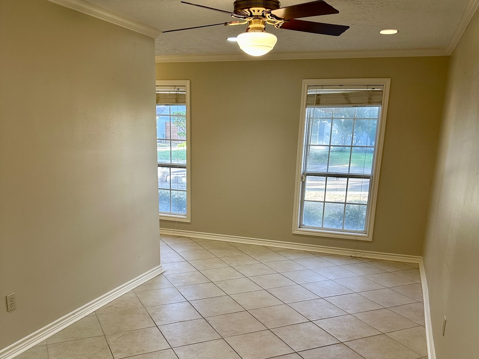 5659 Lymbar Drive Houston, TX 77096 - Photo 13 of 26 an empty room with windows and fan