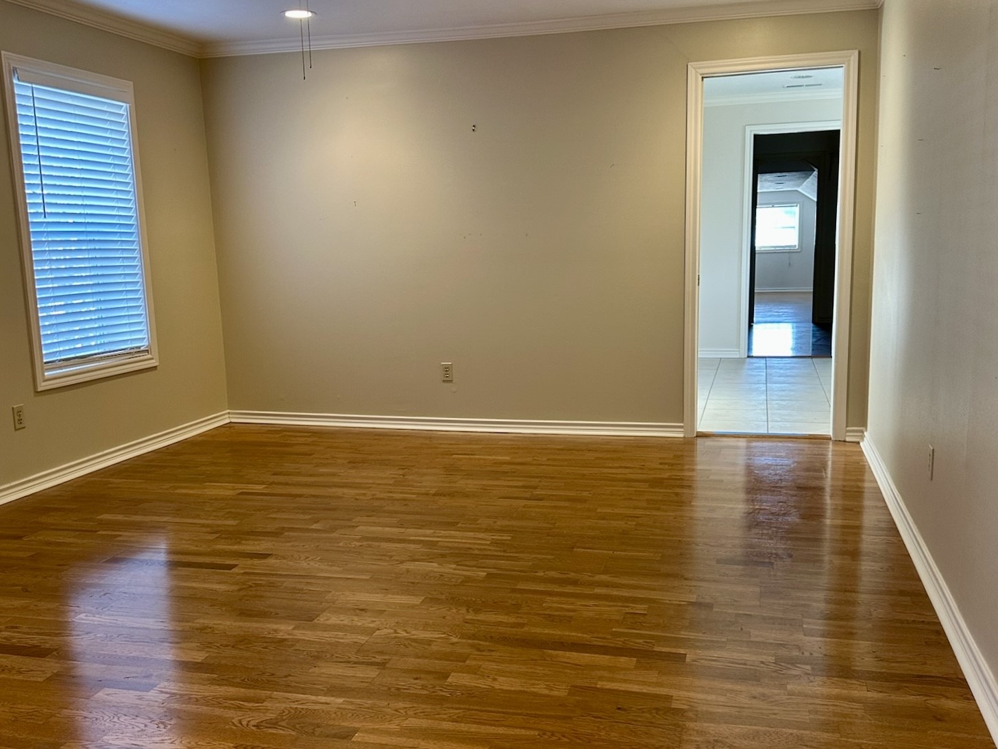 5659 Lymbar Drive Houston, TX 77096 - Photo 15 of 26 a view of an empty room with wooden floor and a window