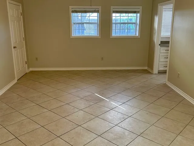 an empty room with a empty space and windows