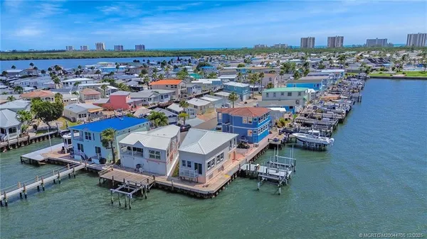 an aerial view of a house with a garden and lake view