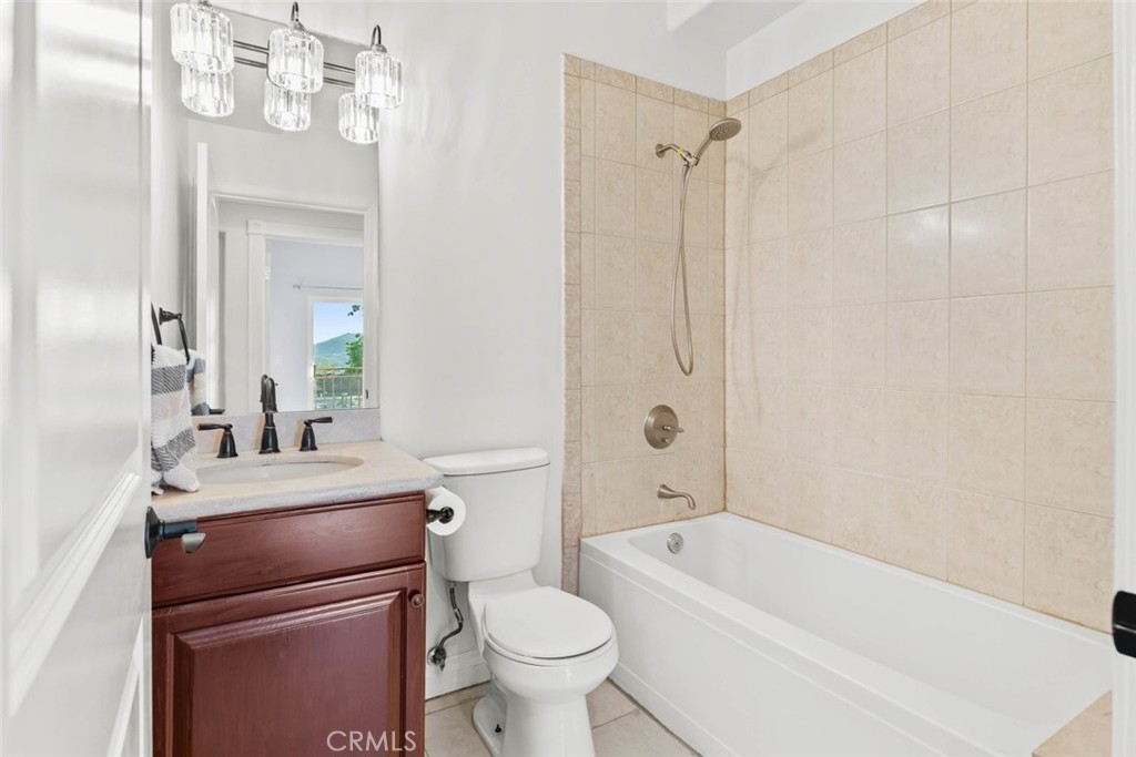 6939 Greeley Street, Unit 102 Tujunga, CA 91042 - Photo 11 of 19 a bathroom with a sink a toilet a mirror and shower