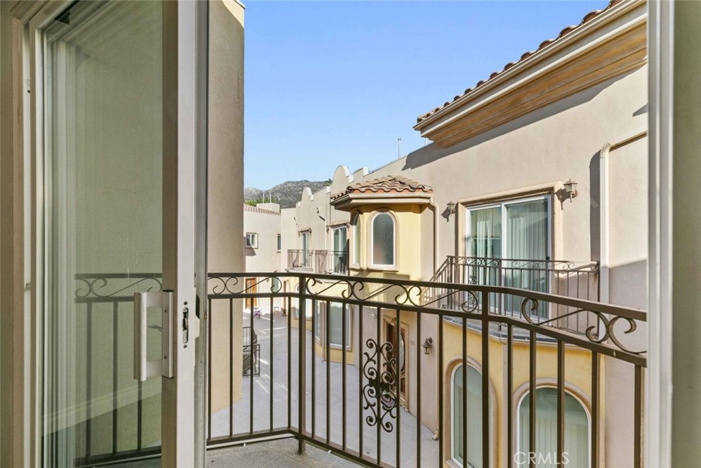 6939 Greeley Street, Unit 102 Tujunga, CA 91042 - Photo 14 of 19 a view of a house with a wooden fence
