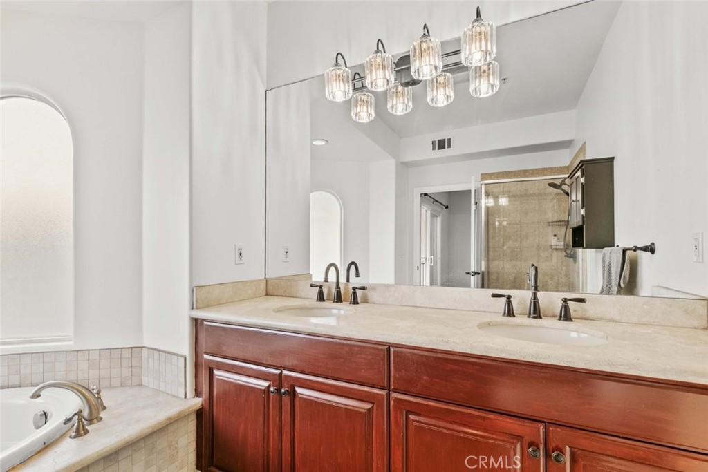 6939 Greeley Street, Unit 102 Tujunga, CA 91042 - Photo 5 of 19 a bathroom with a double vanity sink and a mirror