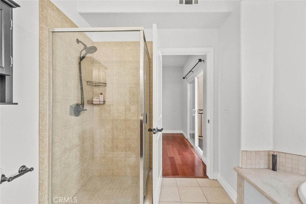 6939 Greeley Street, Unit 102 Tujunga, CA 91042 - Photo 6 of 19 a bathroom with a granite countertop shower mirror and a sink