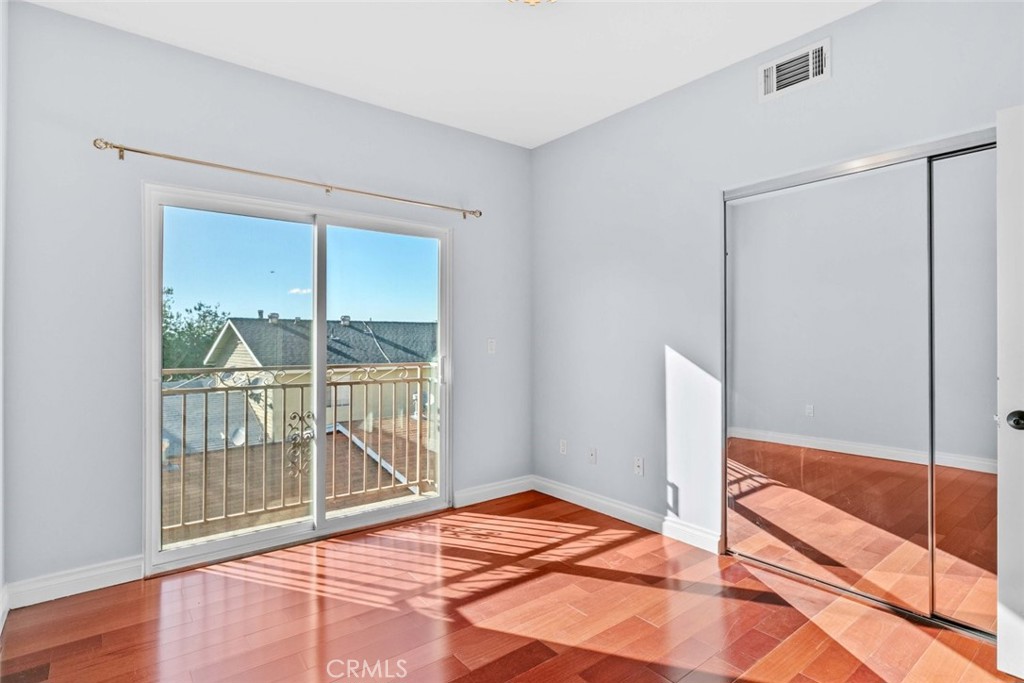 6939 Greeley Street, Unit 102 Tujunga, CA 91042 - Photo 8 of 19 a view of a room with wooden floor and a sliding door