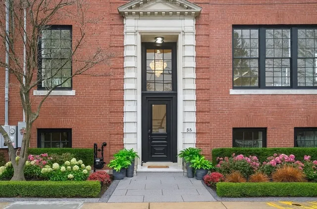 front view of a house with potted plants