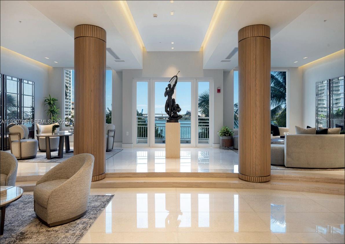 888 Brickell Key Drive, Unit 601 Miami, FL 33131 - Photo 25 of 36 a living room with furniture and wooden floor