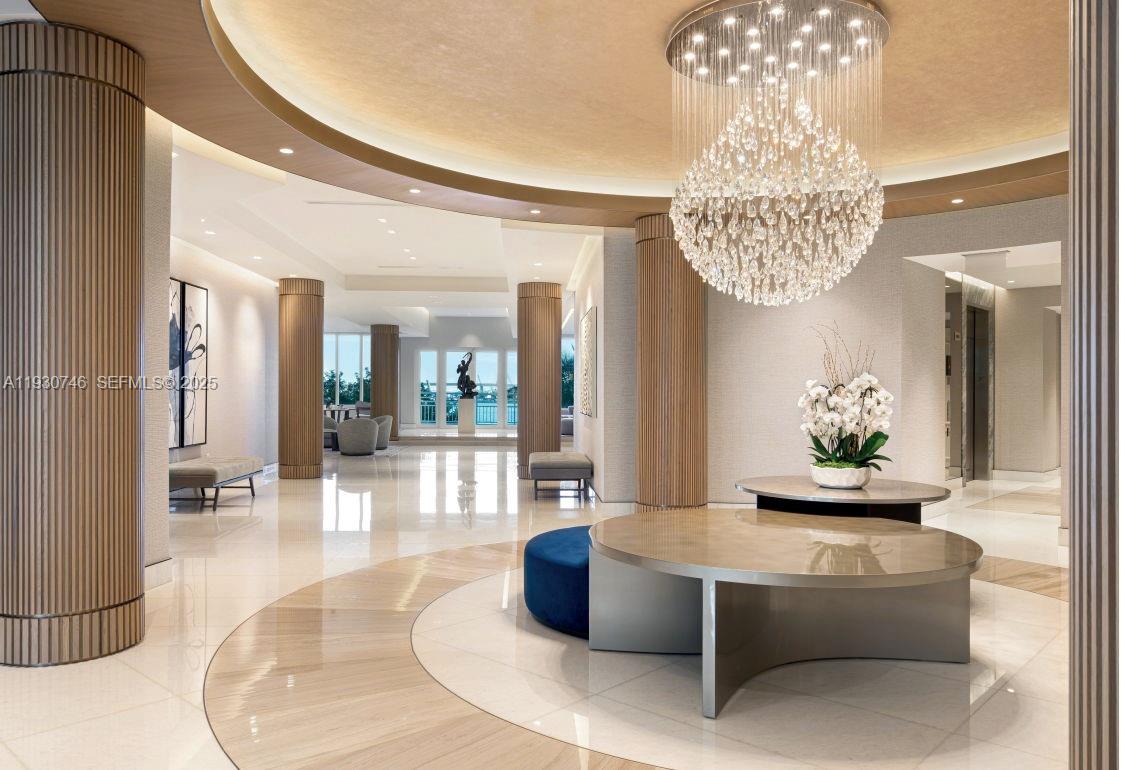 888 Brickell Key Drive, Unit 601 Miami, FL 33131 - Photo 26 of 36 a living room with furniture and a chandelier