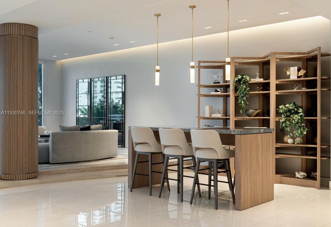 888 Brickell Key Drive, Unit 601 Miami, FL 33131 - Photo 34 of 36 a dining hall with a dining table and chairs with the view of kitchen