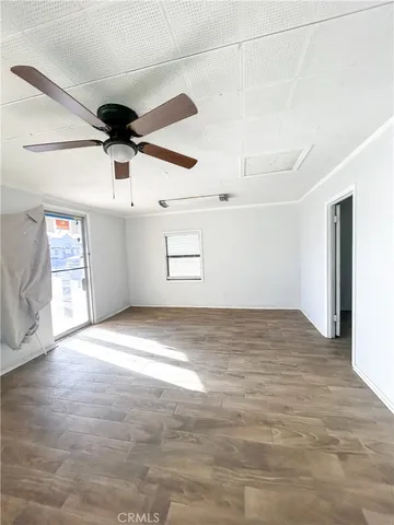 a view of empty room with wooden floor