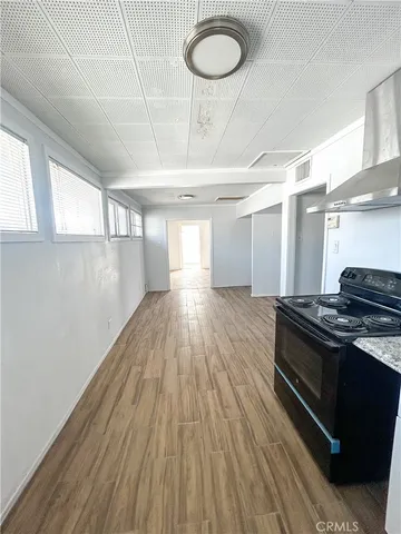 a kitchen with wooden floors and a stove