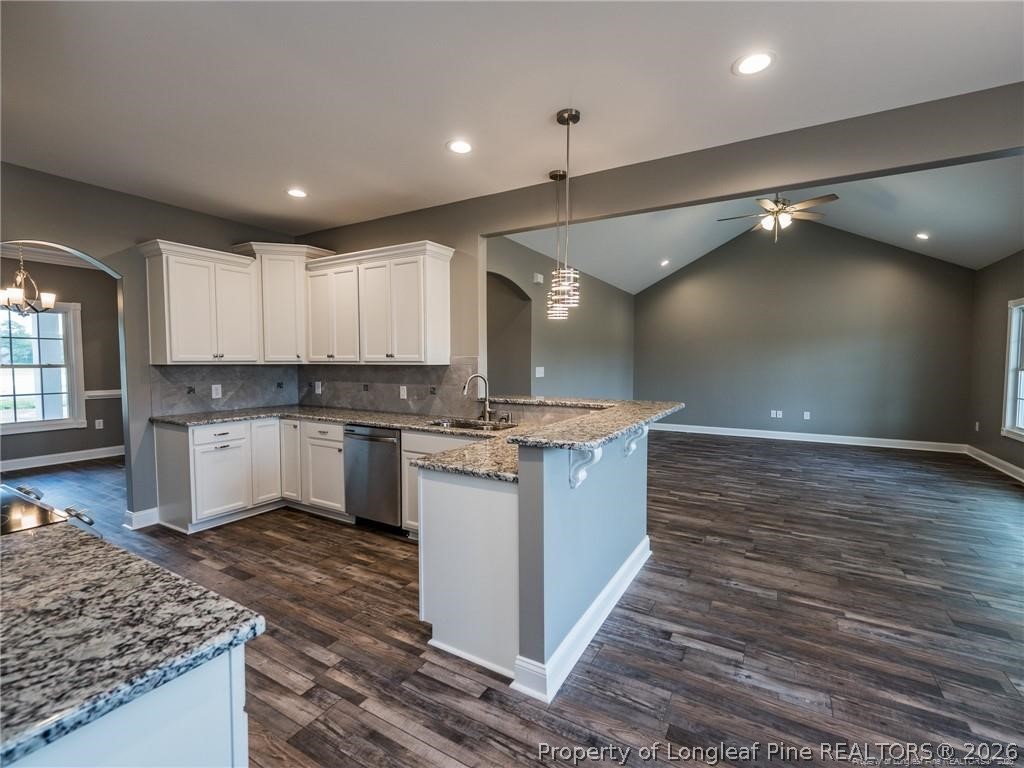 1102 West Carthage Road Lumberton, NC 28360 - Photo 9 of 41 a large kitchen with kitchen island a sink stainless steel appliances and cabinets