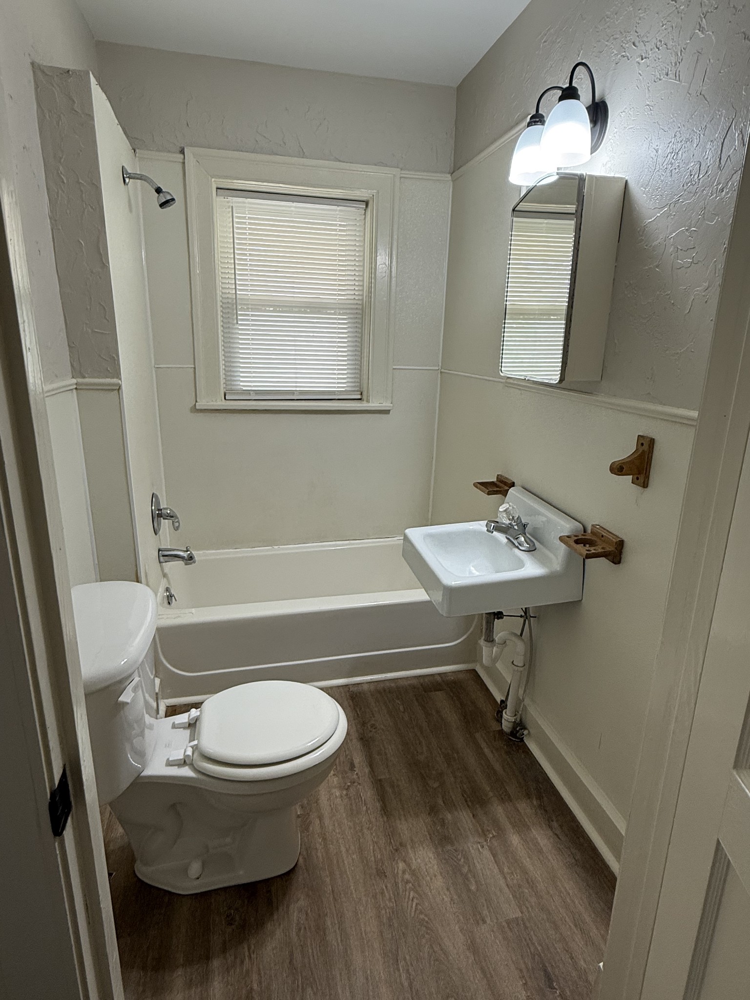 428 2nd Avenue, Unit A Murfreesboro, TN 37130 - Photo 9 of 10 a bathroom with a sink a toilet a mirror and shower