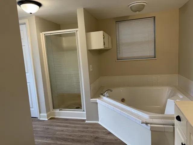 a bathroom with a tub and a shower