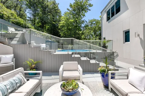 a view of staircase with white walls and railing