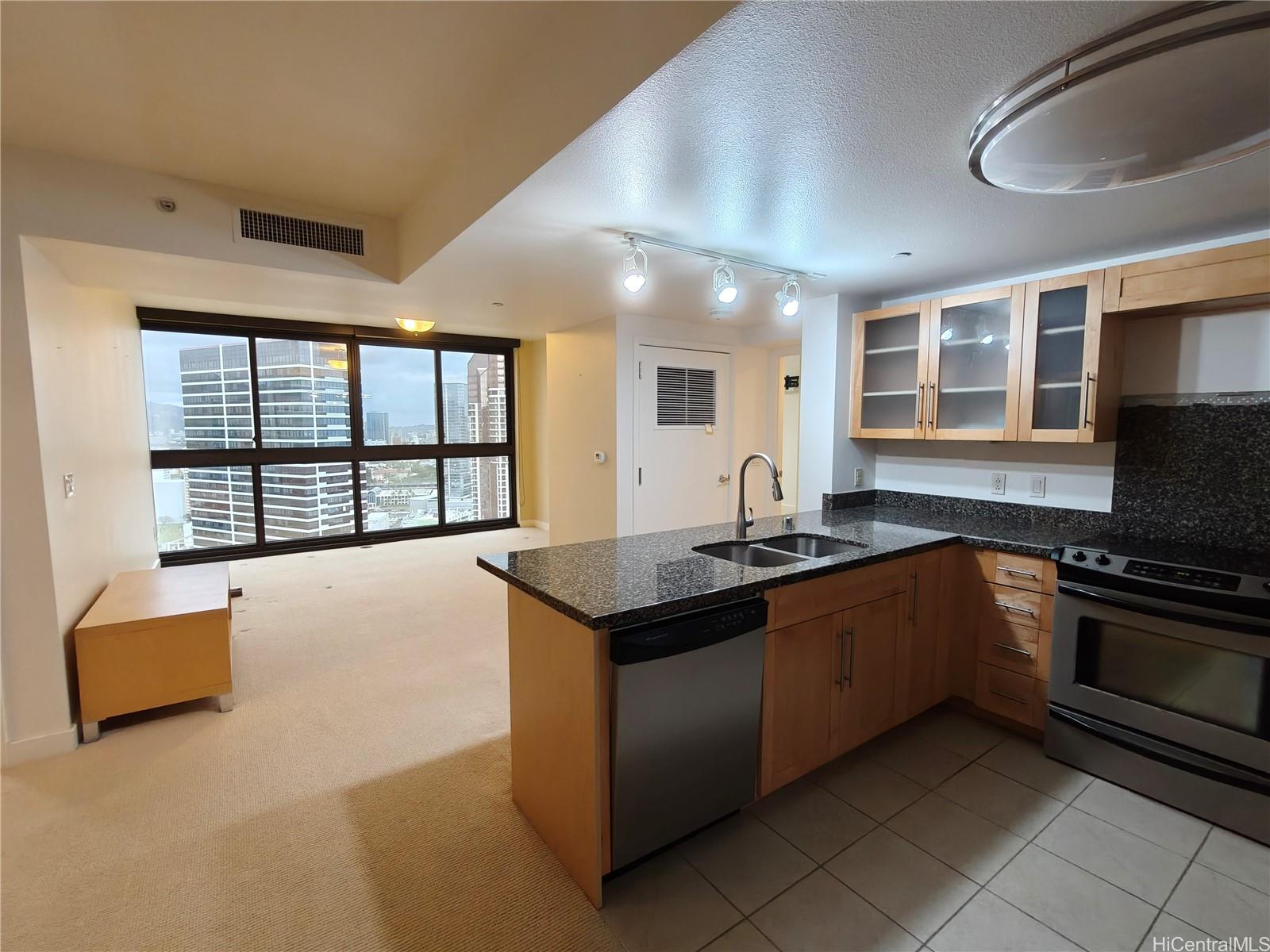 600 Queen Street, Unit 3203 Honolulu, HI 96813 - Photo 2 of 8 a kitchen with stainless steel appliances granite countertop a stove and a sink