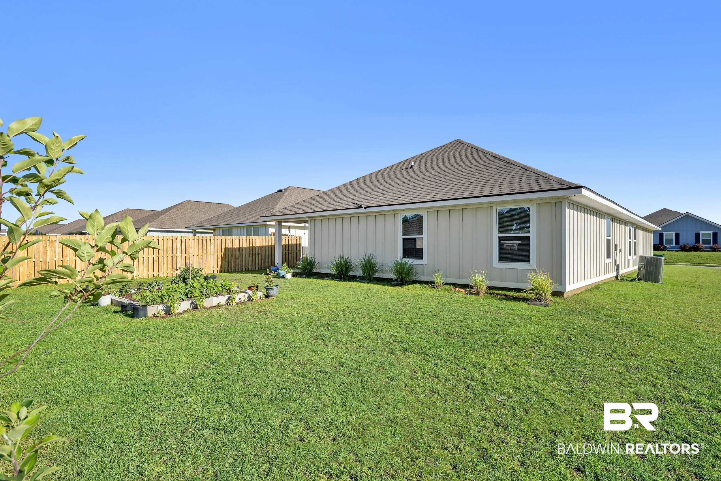 1228 Caper Avenue Foley, AL 36535 - Photo 34 of 54 Expansive grassy yard area featuring a new privacy fence