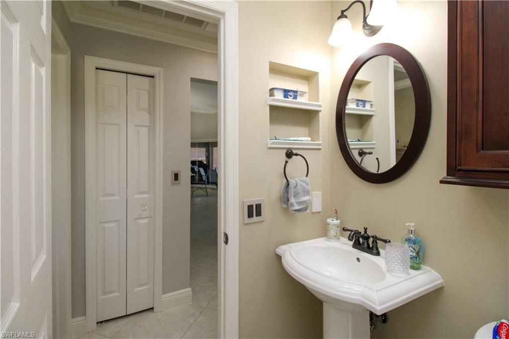 333 Wentworth Court Naples, FL 34104 - Photo 37 of 48 Bathroom with built in features, a closet, a sink, and tile patterned flooring