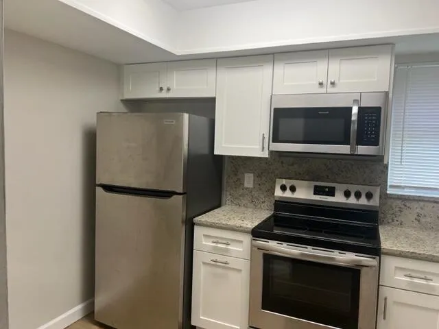 a kitchen with a stove microwave and refrigerator
