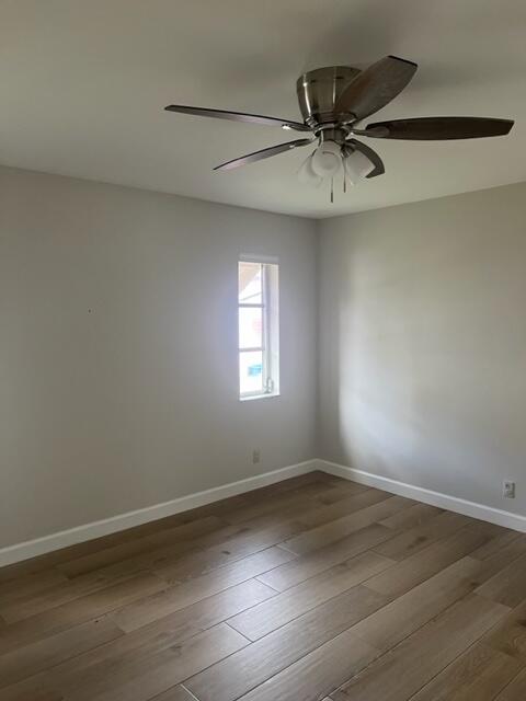500 Northwest 53rd Street Boca Raton, FL 33487 - Photo 7 of 13 an empty room with wooden floor fan and windows