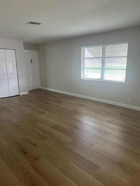 500 Northwest 53rd Street Boca Raton, FL 33487 - Photo 8 of 13 an empty room with wooden floor and windows