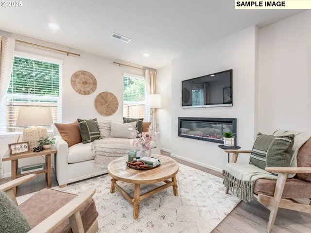 a living room with furniture fireplace and window