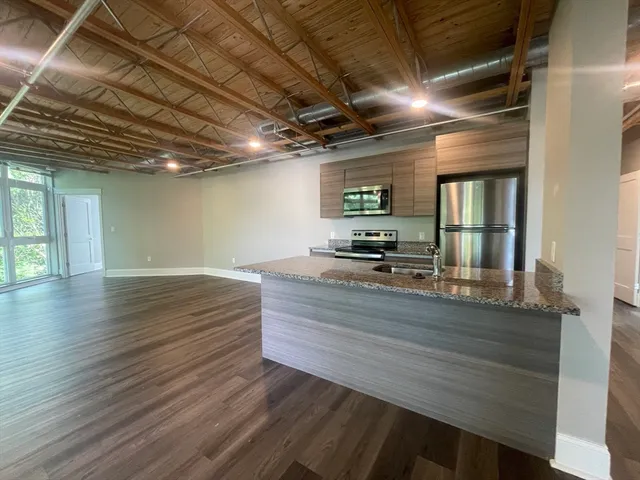 a view of room with wooden floor