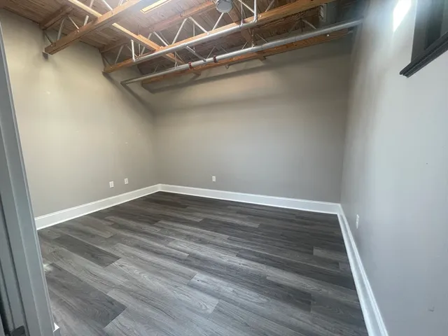 a view of a room with wooden floor
