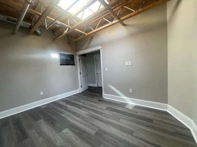 a view of a room with wooden floor